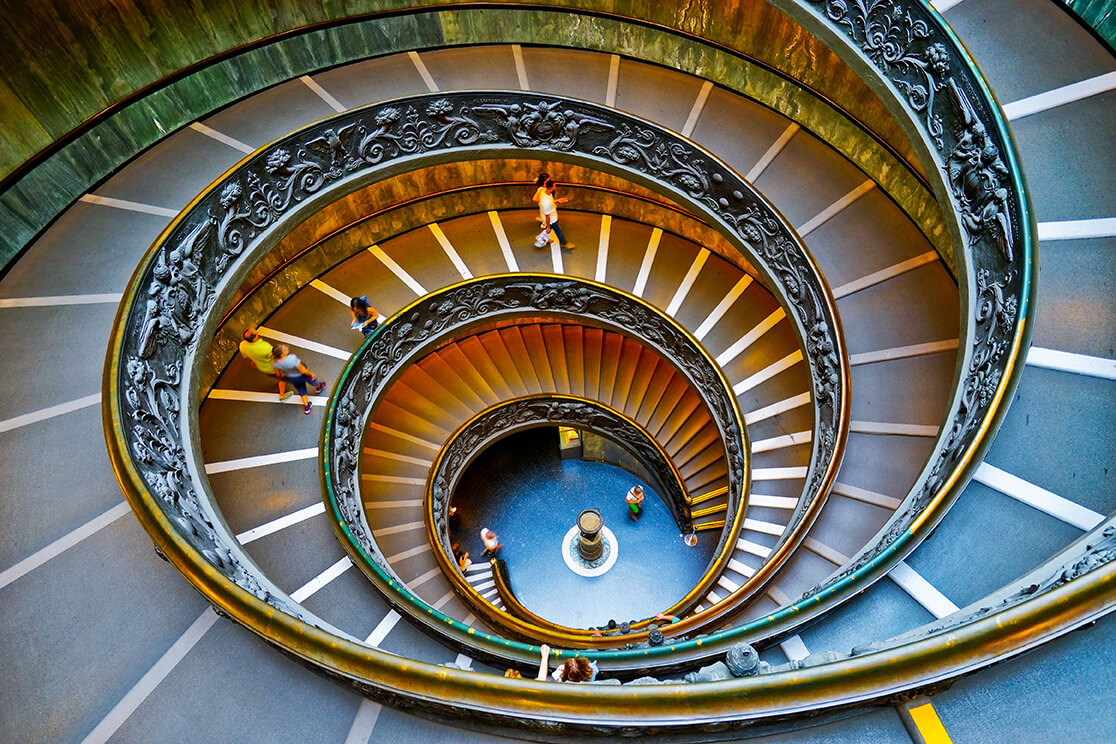 A Vatican Museums gallery lined with rows of classical marble sculpture