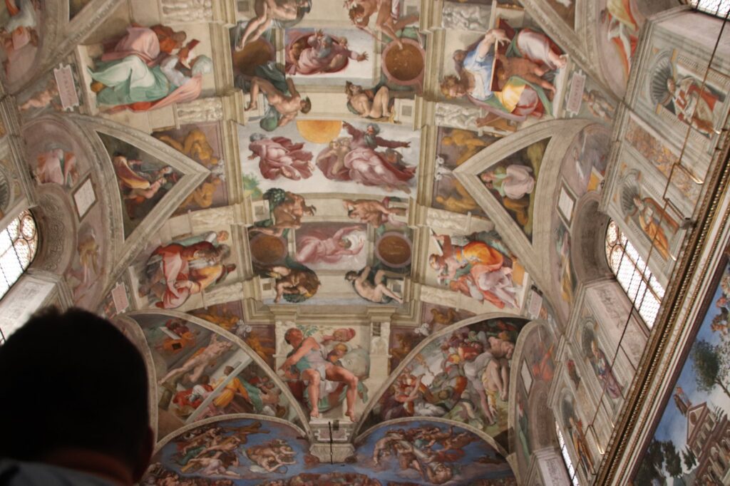 The Sistine Chapel ceiling by Michelangelo, where the Vatican dress code is strictly enforced at the door